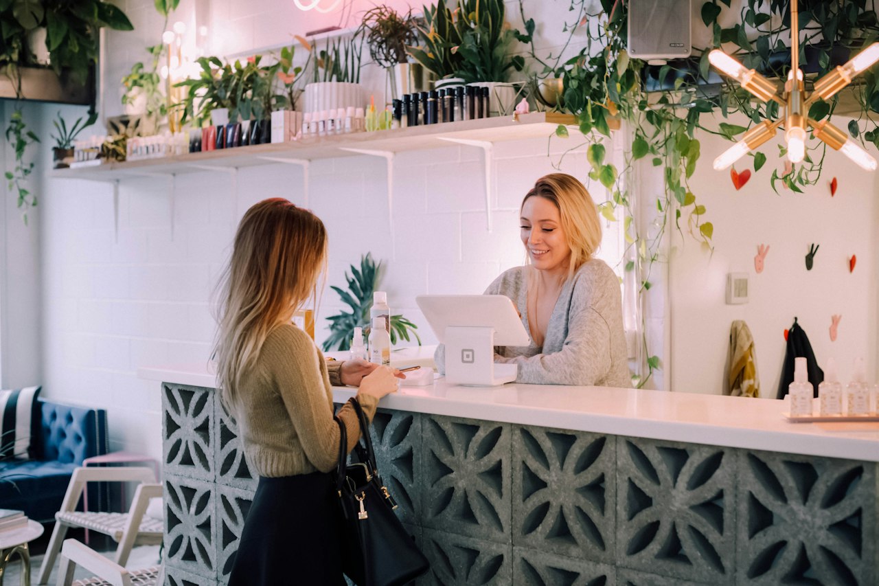 A customer paying at the counter of an independent shop