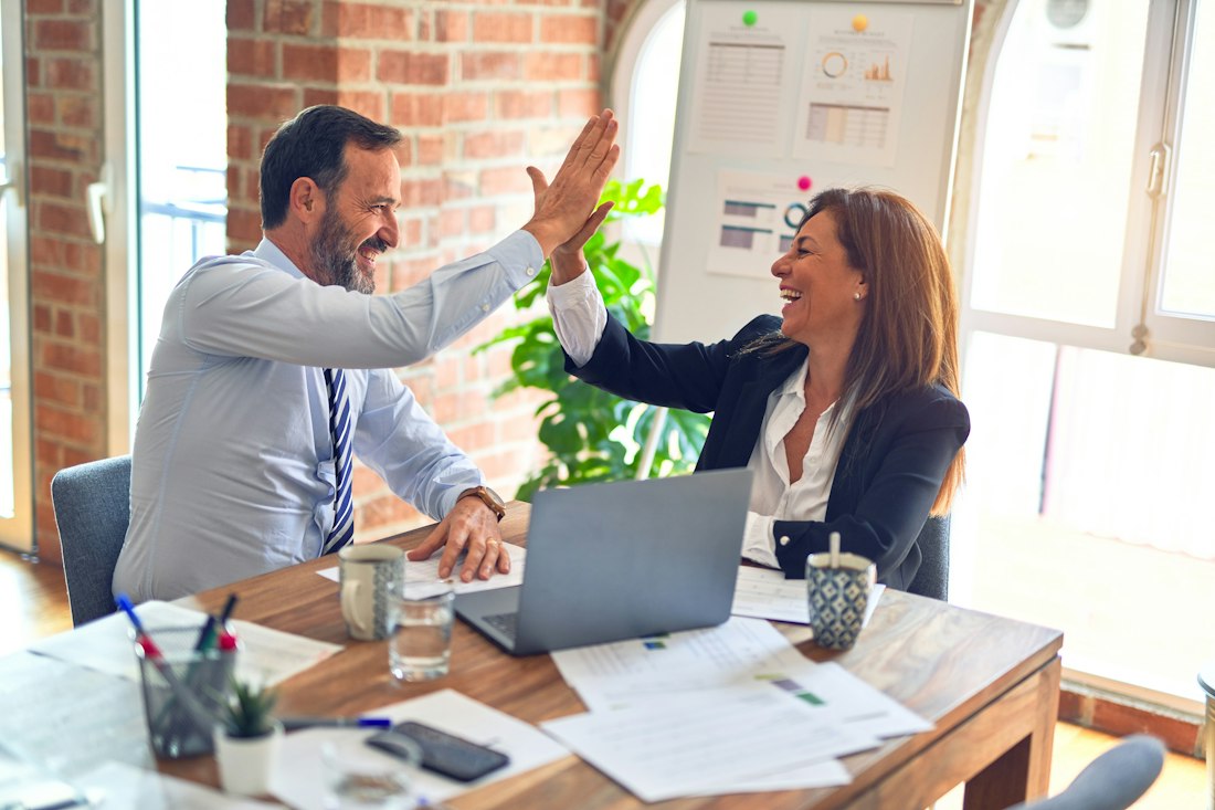 Business owners celebrating a good set of accounts with their accountant