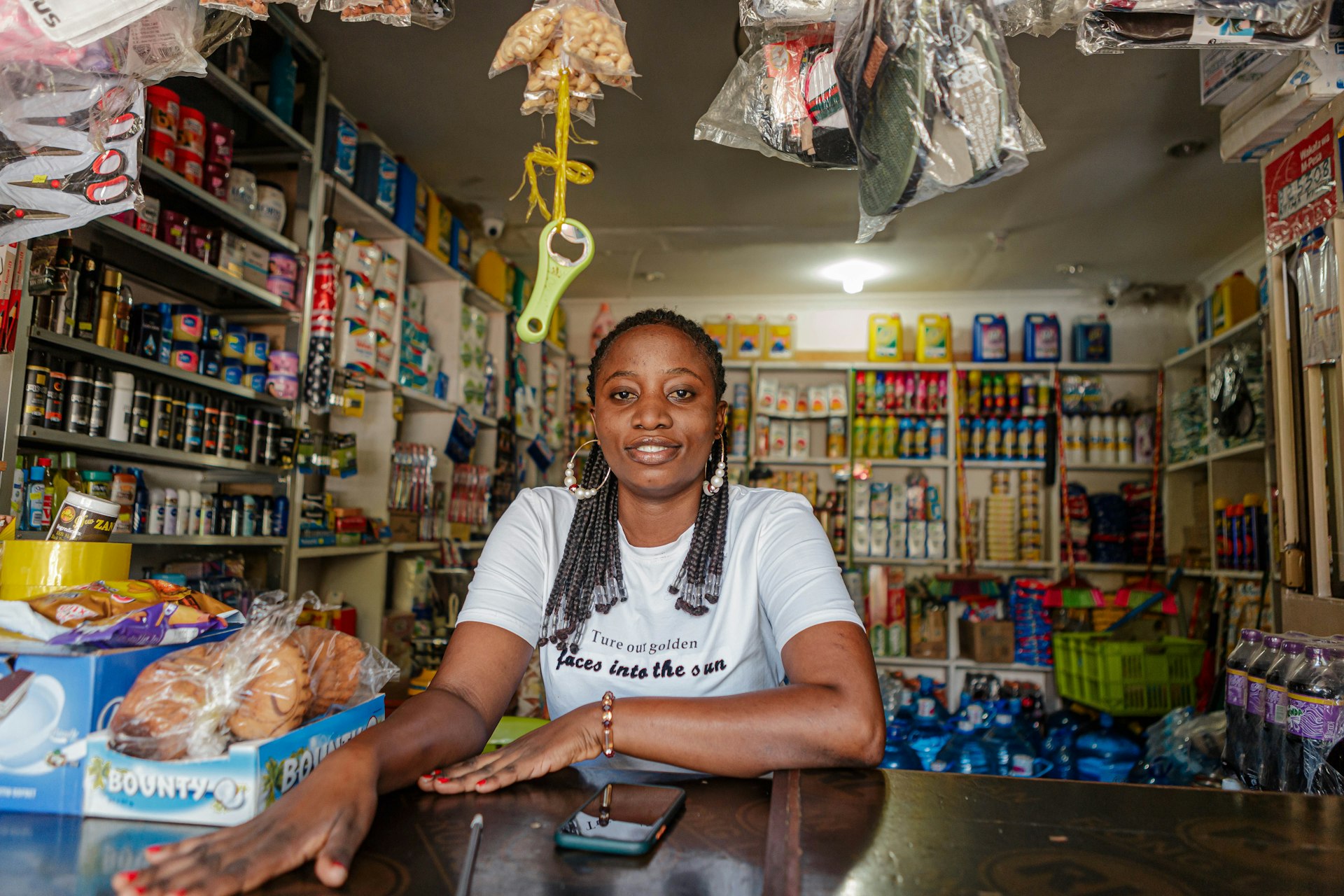 A shop owner behind the counter of her business