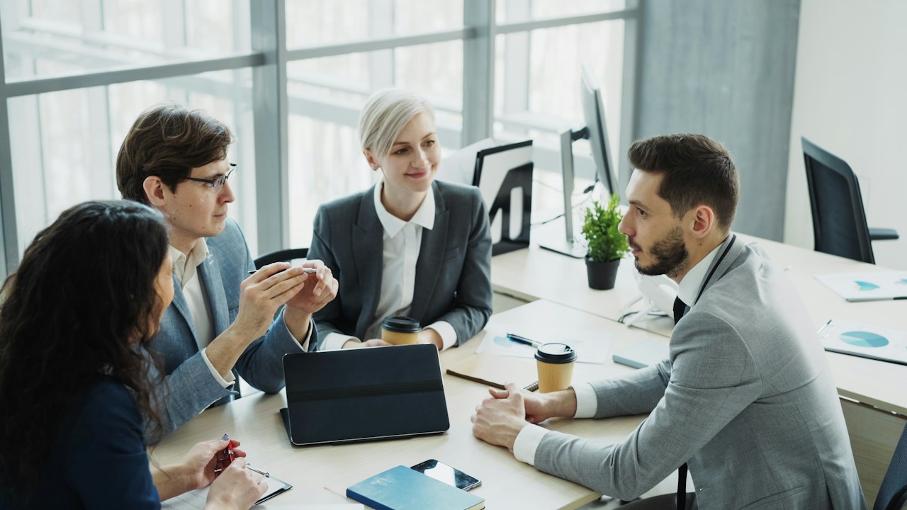 A team going over payroll figures together in the office